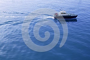 Blue Mediterranean Sea with pilots boat