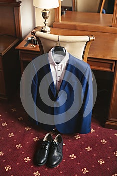 Blue men& x27;s suit and black groom & x27;s shoes.