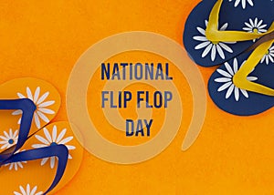 Blue men's and yellow women's beach slippers on an orange background. National flip flops day concept. An