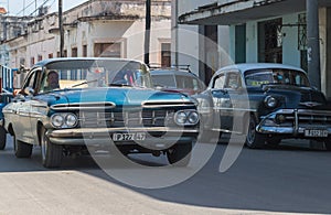 Blue merican vintage car drives in the province Villa Clara in Cuba on the street