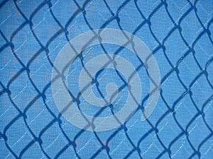 Blue mesh fencing with shadows