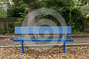 Blue metal bench in public park