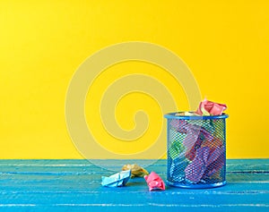 blue metal bucket filled with crumpled  paper