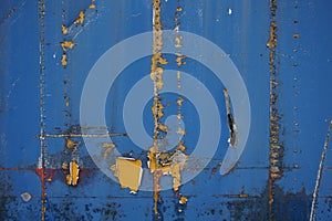 Blue metal container wall with paint peeling off