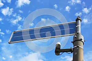 Blue, metal, empty street sign with cloudy sky