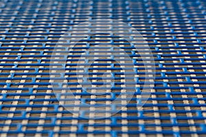 Blue metal mesh texture with rectangular holes