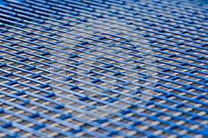 Blue metal mesh texture with rectangular holes