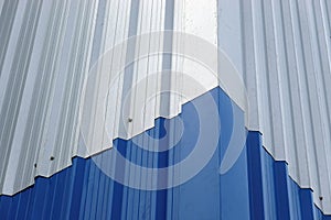 Blue Metal sheet wall panels and roofs,  Abstract background.Blue color and Silver color Metal Sheet or Blue Color and Silver