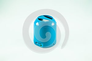 Blue mini portable speaker on a white backrground.