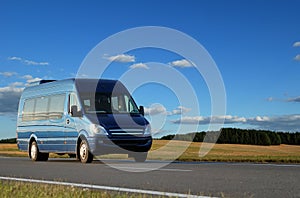 Blue minibus on highway