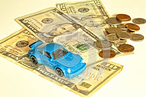 Blue model car and dollar bills