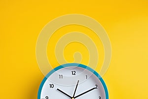 Blue modern clock on yellow color background
