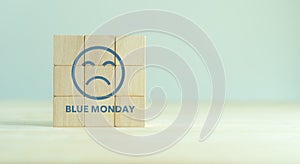 Blue monday concept. Wooden cubes with a sad face drawn. Monday blues