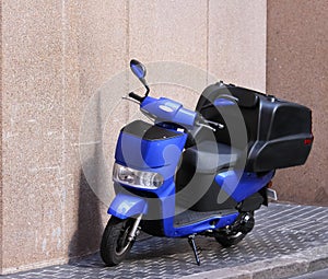 Blue moped motorcycle on city pavement