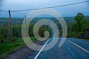 A blue morning on a country road with a big steep hill