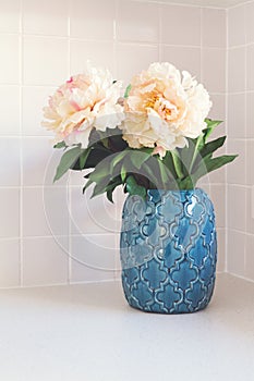 Blue moroccan vase with large white flowers