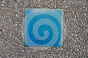 Blue mosaic inserted between arenaceous rock.