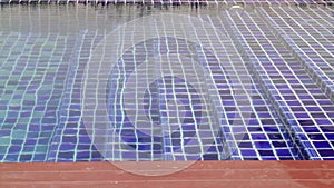 Blue mosaic tile stairs of swimming pool