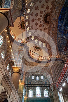 The blue mosque beautiful interior ornamental decoration of dome ceiling, arch windows and columns and lighting with historical