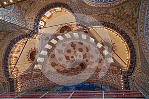 The blue mosque interior dome ceiling beautiful ornamental decoration and lighting with historical restoration framework
