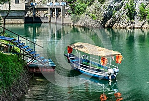 Blue motor boat docked in the small lake bay