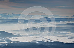 Blue mountain ridges and snowfields in hazy valleys in Slovakia