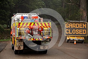 Blue Mountains, Australia - 2020-01-12 Rural Fire Service firetruck on the road near the sign Garden Closed at Mt. Tomah, Blue