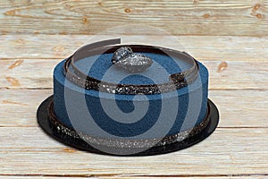 Blue mousse cake on white wooden background photo