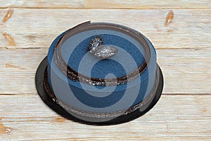 Blue mousse cake on wooden background photo