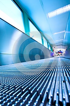 Blue moving escalator in the office hall