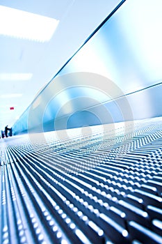 Blue moving escalator in the office hall