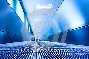Blue moving escalator in the office hall