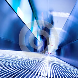 Blue moving escalator in the office hall