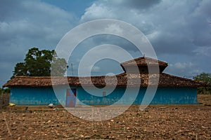 A blue mud house in a village in Central India