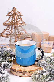 Blue mug with hot tea with milk, coffee or cocoa on winter holi