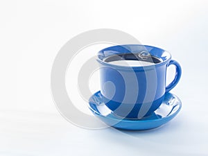 Blue mug with steaming hot coffee. Soft smoke. White background.