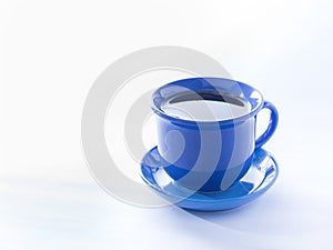 Blue mug with steaming hot coffee. Soft smoke. White background.