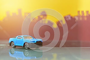 Blue muscle car toy selective focus on blur city background