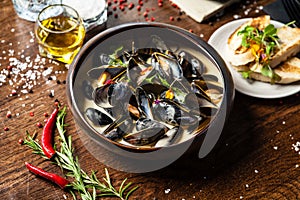 Blue mussels in cream wine sauce. Delicious healthy Italian traditional food closeup served for lunch in modern gourmet