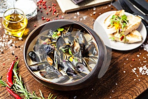 Blue mussels in cream wine sauce. Delicious healthy Italian traditional food closeup served for lunch in modern gourmet