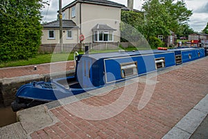 Blue narrowboat in a lock chamber