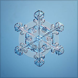 Blue natural snowflake macro piece of ice