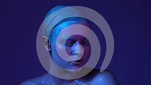 Blue neon makeup on womans face