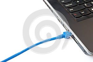 Blue network cable connecting to a laptop