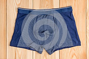 Blue new cotton panties for boy clothes on wooden boards top vie