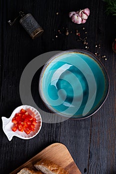 Blue nice bowl and ingredients served at dark wooden table. meditarranean cuisine. flat lay photo