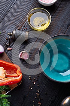 Blue nice bowl and ingredients served at dark wooden table. meditarranean cuisine. flat lay photo