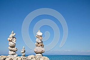 Blue ocean background with a pillar of stones for meditative or