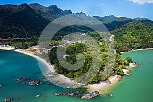 Blue ocean with a green shoreline and a mountain in the background, Pantai Kok, Langkawi,Malaysia