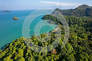 Blue ocean with a green shoreline and a mountain in the background, Tuba island,Malaysia